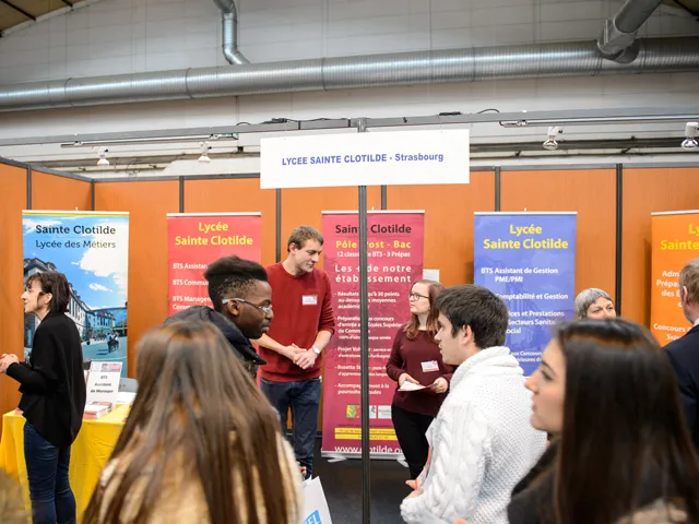 Attendees at a job fair mingling and networking