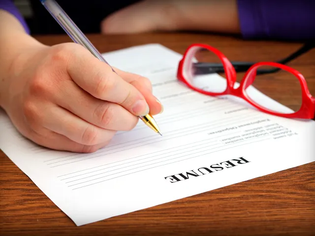A person writing a resume